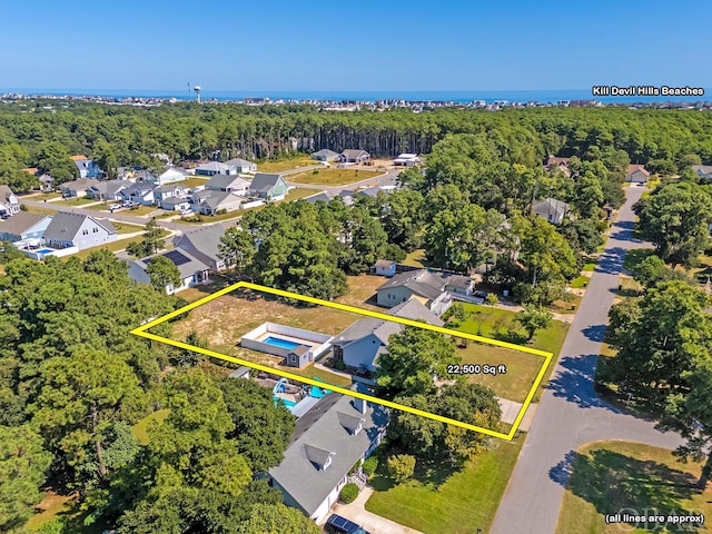 drone / aerial view with a residential view and a wooded view