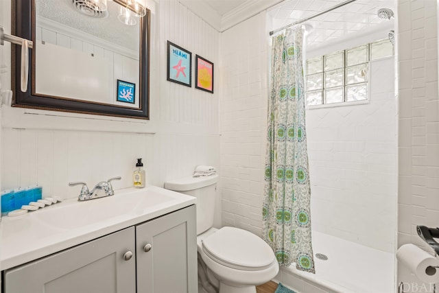 full bathroom featuring toilet, a shower stall, vanity, and crown molding