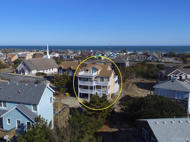 birds eye view of property with a water view and a residential view