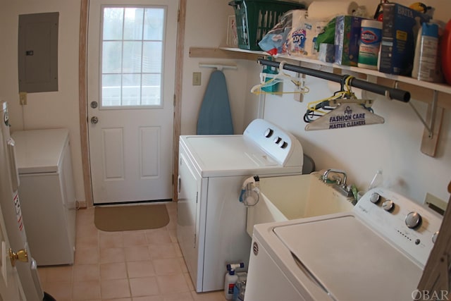 laundry room with laundry area, electric panel, a sink, and washing machine and clothes dryer