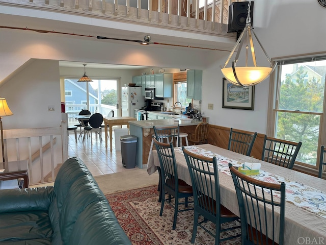 dining room featuring light tile patterned floors and a high ceiling