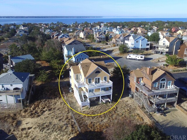 birds eye view of property with a residential view and a water view