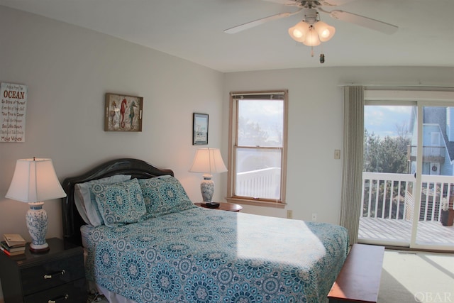 bedroom with access to exterior, multiple windows, and a ceiling fan