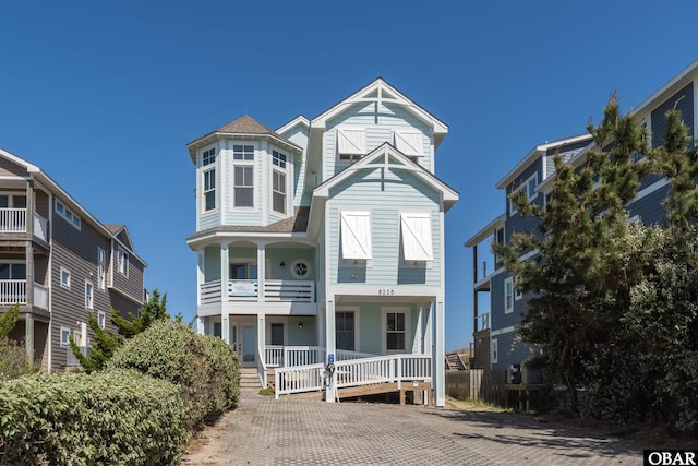 8225 S Old Oregon Inlet Rd Lot 52, Nags Head, NC 27959 - victorian home featuring a porch, a balcony, and roof with shingles