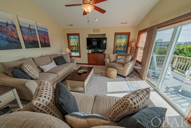 living room with lofted ceiling, carpet, visible vents, and ceiling fan