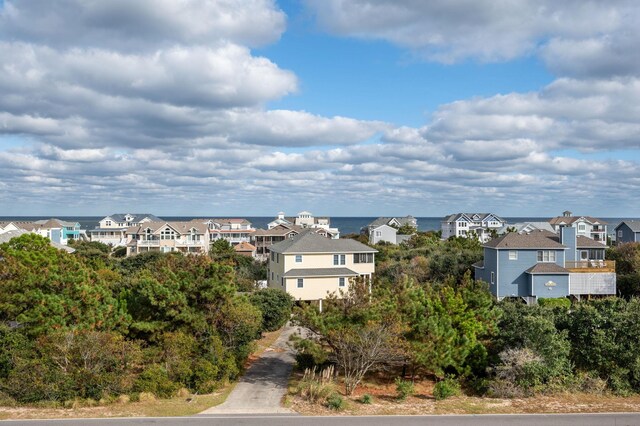 birds eye view of property featuring a water view and a residential view