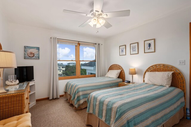 bedroom featuring baseboards, a ceiling fan, and light colored carpet