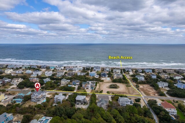 drone / aerial view with a residential view and a water view