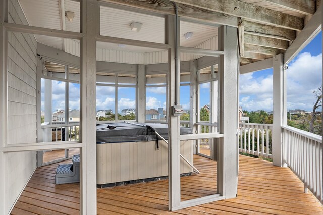 wooden deck featuring a hot tub