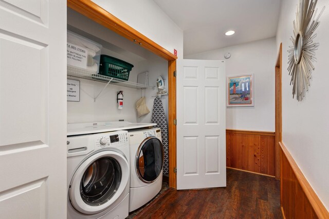 laundry room featuring laundry area, a wainscoted wall, dark wood-style floors, independent washer and dryer, and wood walls