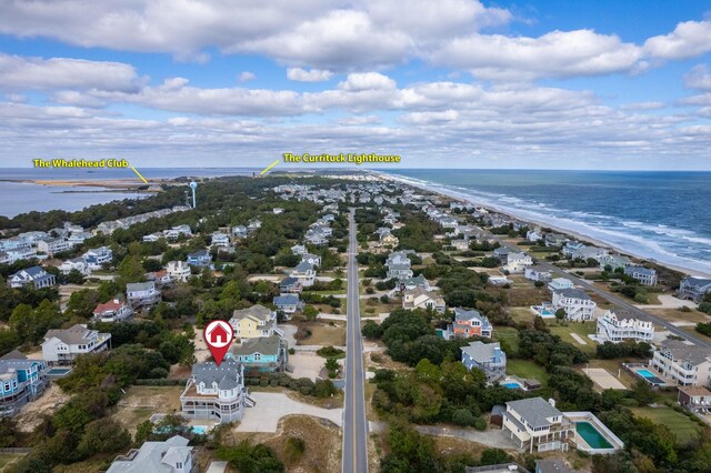 aerial view featuring a water view, a residential view, and a view of the beach