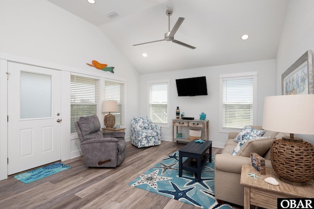 living room featuring a wealth of natural light, a ceiling fan, wood finished floors, and visible vents