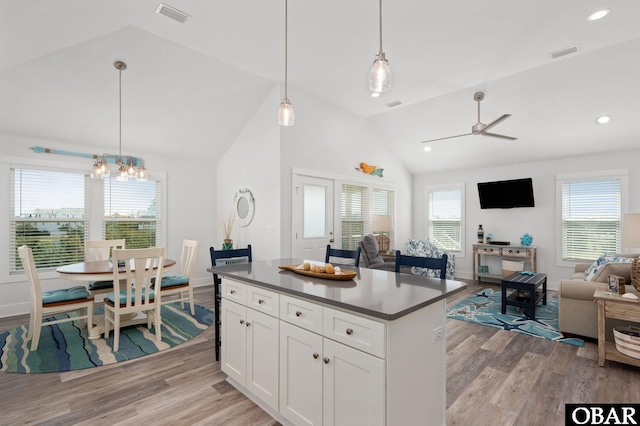 kitchen featuring visible vents, light wood-style flooring, and lofted ceiling