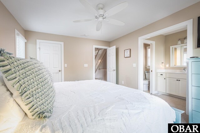 bedroom featuring carpet, ceiling fan, and ensuite bathroom