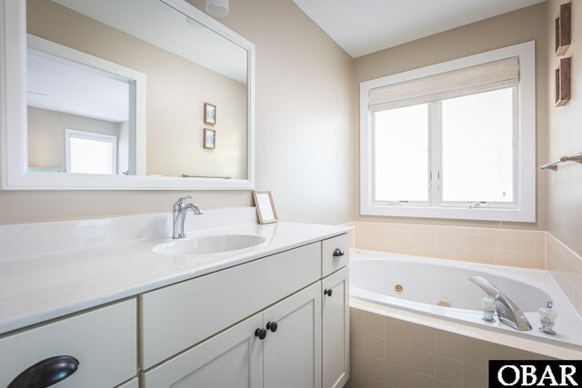 full bath featuring vanity and a tub with jets