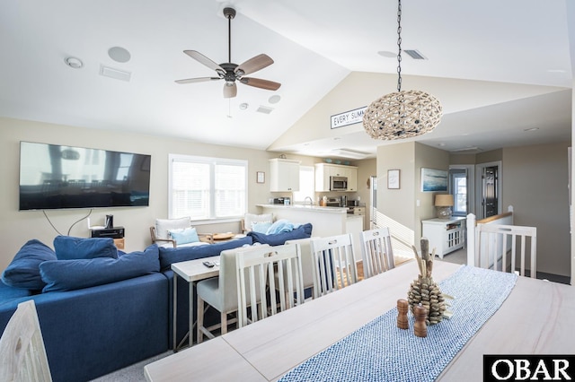 dining room featuring visible vents, vaulted ceiling, and ceiling fan