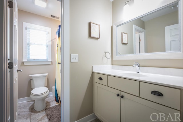 bathroom with toilet, baseboards, visible vents, and vanity