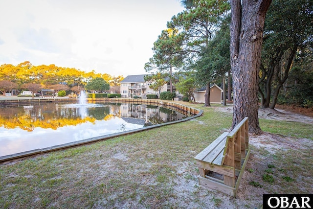 exterior space with a lawn and a water view