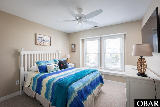 bedroom featuring light carpet, baseboards, visible vents, and a ceiling fan