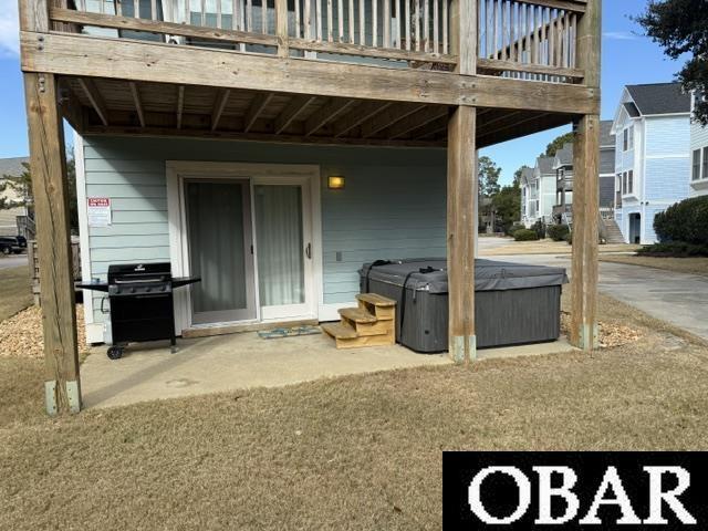 exterior space with area for grilling and a hot tub