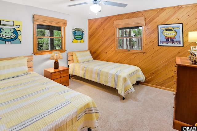 1127 Brumsey Ct Lot 324, Corolla, NC 27927 - bedroom featuring carpet, wood walls, and ceiling fan