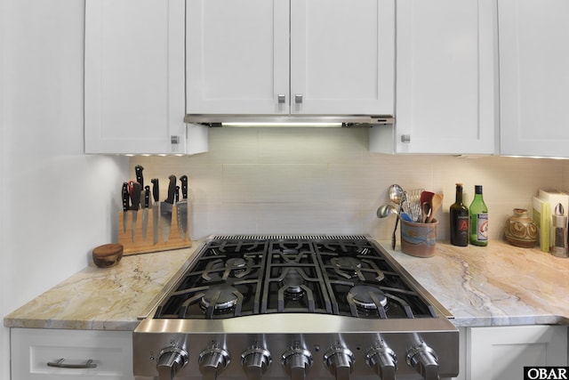 1127 Brumsey Ct Lot 324, Corolla, NC 27927 - kitchen featuring white cabinetry, tasteful backsplash, light stone counters, stainless steel range with gas cooktop, and under cabinet range hood