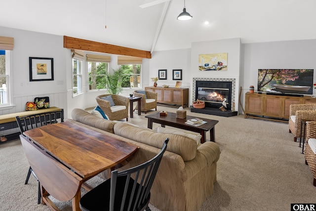 1127 Brumsey Ct Lot 324, Corolla, NC 27927 - carpeted living area featuring a tile fireplace and a wainscoted wall