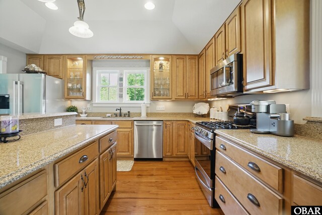 109 Cooper Landing Dr Lot 7, Aydlett, NC 27916 - kitchen featuring appliances with stainless steel finishes, vaulted ceiling, light wood-type flooring, a sink, and light stone countertops