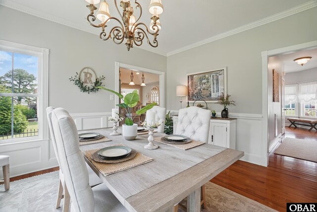 109 Cooper Landing Dr Lot 7, Aydlett, NC 27916 - dining space with a chandelier, a decorative wall, wood finished floors, wainscoting, and ornamental molding