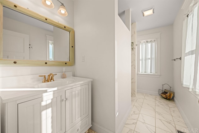 bathroom with marble finish floor, visible vents, baseboards, and vanity