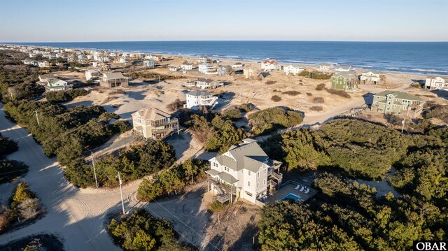 birds eye view of property featuring a water view and a view of the beach