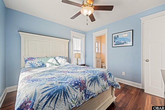 bedroom with ensuite bath, ceiling fan, baseboards, and dark wood-type flooring