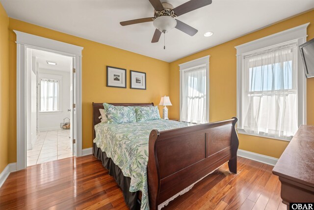 bedroom featuring ceiling fan, recessed lighting, wood finished floors, and baseboards