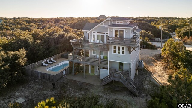 back of house with a patio area, a deck, a balcony, a fenced backyard, and stairs