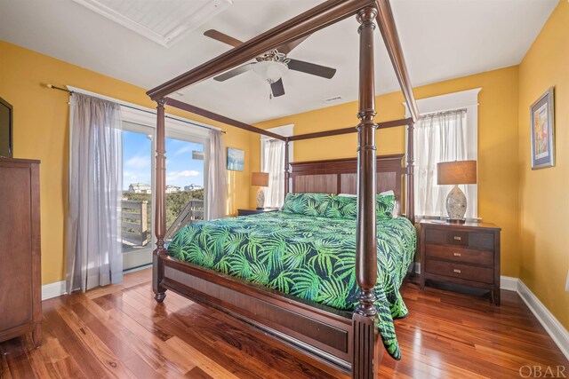 bedroom featuring ceiling fan, wood finished floors, and baseboards