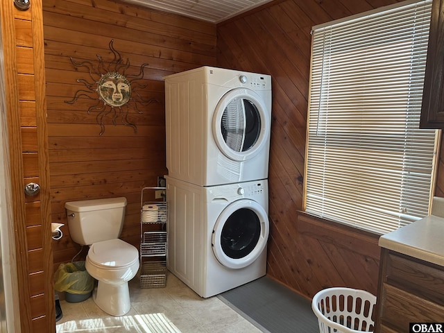 1232 S Virginia Dare Trl Lot 6, Kill Devil Hills, NC 27948 - washroom featuring stacked washer / dryer, wood walls, and light tile patterned floors
