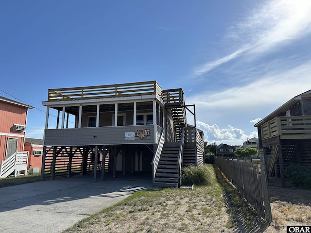 1232 S Virginia Dare Trl Lot 6, Kill Devil Hills, NC 27948 - raised beach house featuring stairs, a carport, and driveway