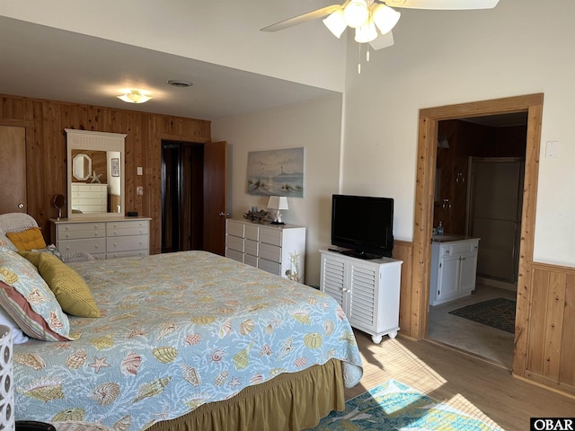 1232 S Virginia Dare Trl Lot 6, Kill Devil Hills, NC 27948 - bedroom featuring wooden walls, wood finished floors, a wainscoted wall, and connected bathroom