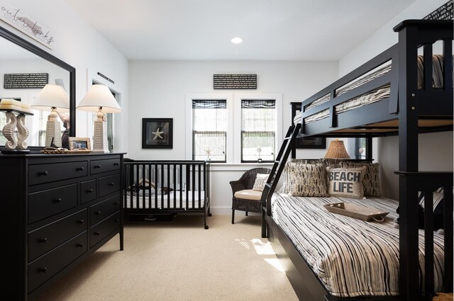 bedroom with recessed lighting, light carpet, and baseboards