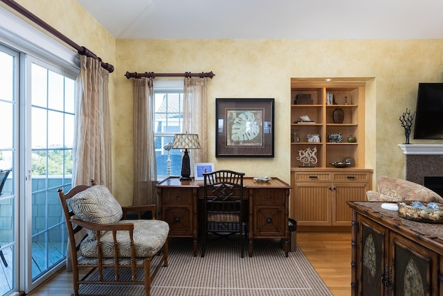 sitting room featuring a fireplace and wood finished floors