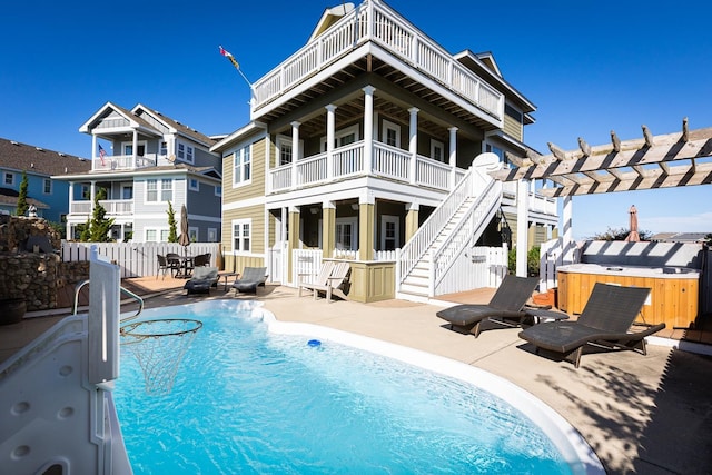 back of house with a fenced in pool, a hot tub, a patio area, fence, and a pergola