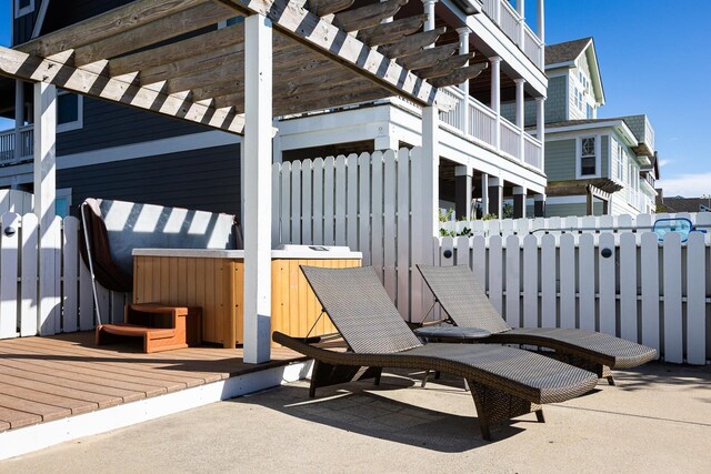 exterior space featuring a jacuzzi, a deck, and a pergola