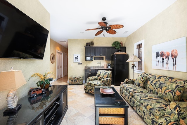 living area with visible vents and ceiling fan