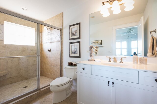 full bath featuring toilet, tile patterned flooring, vanity, and a wealth of natural light