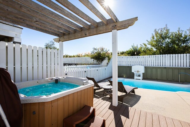 view of swimming pool featuring a fenced in pool, a hot tub, a pergola, a fenced backyard, and a wooden deck