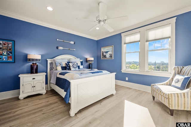 bedroom with baseboards, light wood-style floors, and crown molding