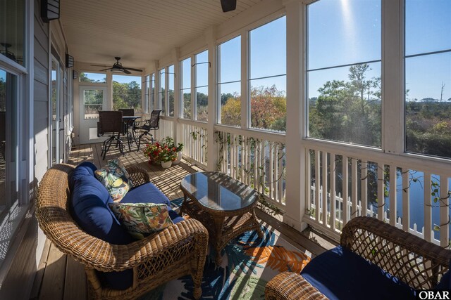 sunroom featuring ceiling fan