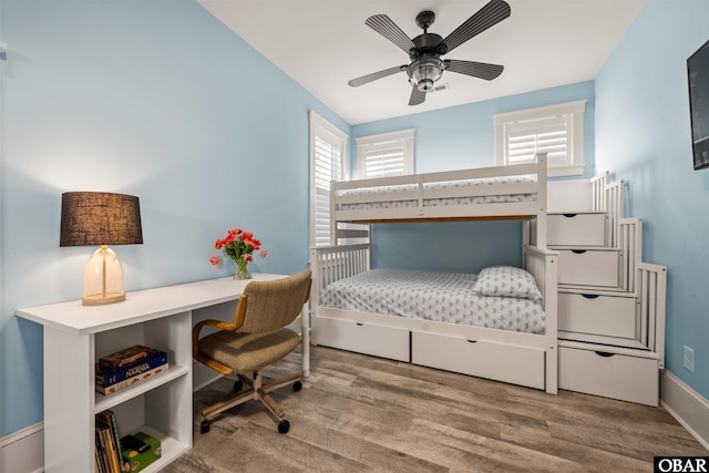 bedroom with baseboards and wood finished floors