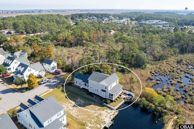 birds eye view of property with a wooded view