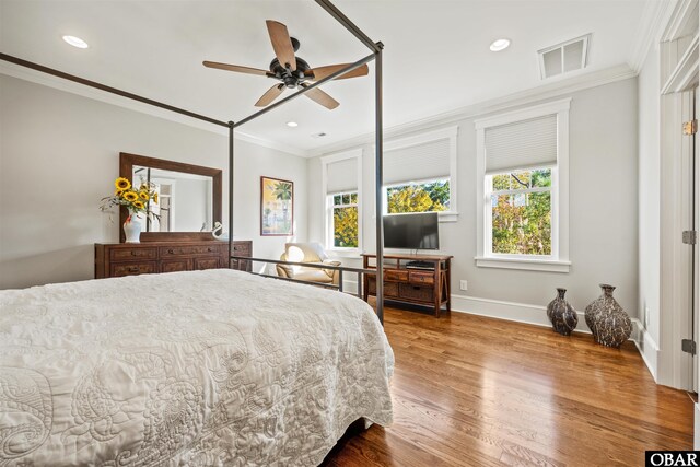 bedroom featuring visible vents, wood finished floors, recessed lighting, crown molding, and baseboards